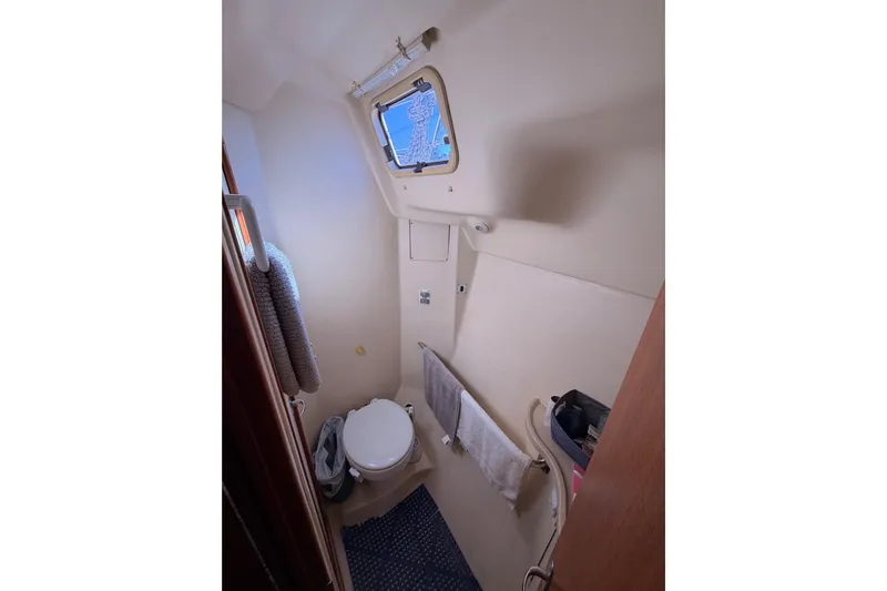 Thursday's Child Yacht Photos Pics Compact bathroom in 2005 Hunter Passage 456 yacht, featuring a toilet and towel rack.