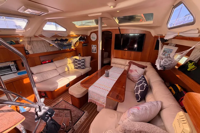 Thursday's Child Yacht Photos Pics Luxurious interior of 2005 Hunter Passage 456 yacht with cozy seating and elegant decor.