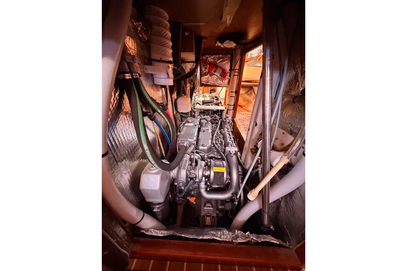 Thursday's Child Yacht Photos Pics Engine compartment of 2005 Hunter Passage 456 sailboat, showcasing detailed mechanical components.