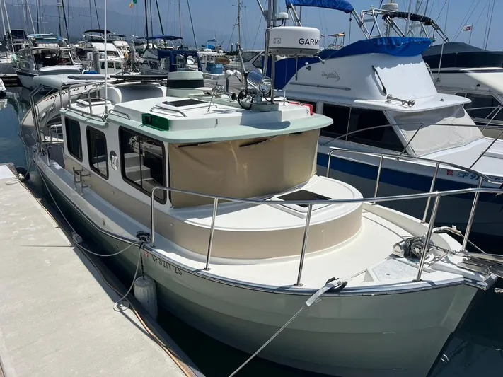 Ben Yacht Photos Pics 2011 Ranger Tugs R-27 docked at marina, surrounded by other boats.