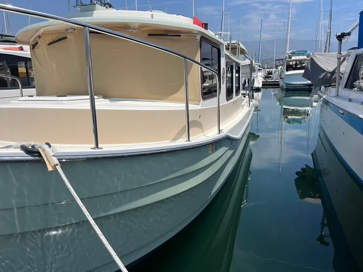 Ben Yacht Photos Pics 2011 Ranger Tugs R-27 boat docked in a marina, reflecting on calm water.