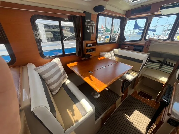 Ben Yacht Photos Pics Interior of 2011 Ranger Tugs R-27 with dining area and striped cushions.