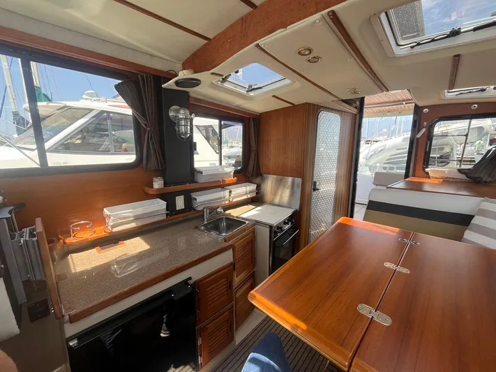 Ben Yacht Photos Pics Interior of 2011 Ranger Tugs R-27 boat with kitchen and dining area.