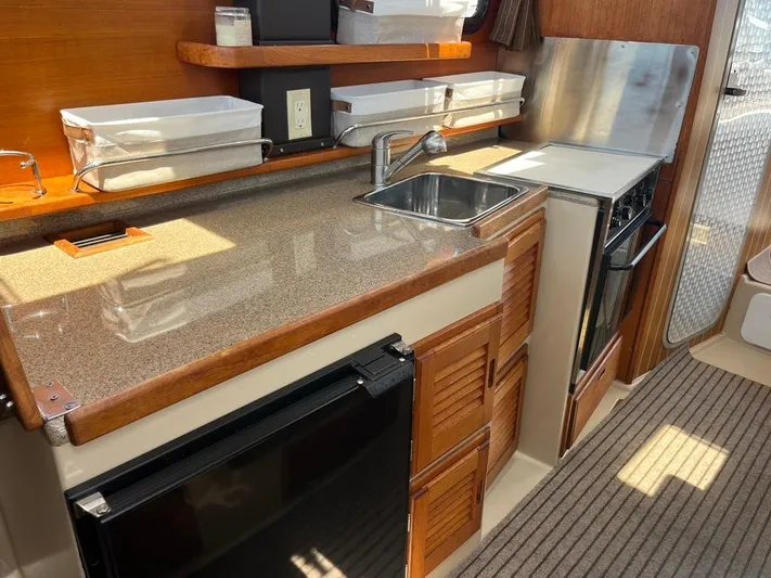 Ben Yacht Photos Pics 2011 Ranger Tugs R-27 galley with sink, stove, and storage cabinets.