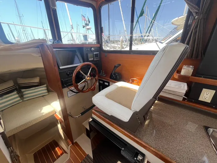 Ben Yacht Photos Pics Interior of 2011 Ranger Tugs R-27 boat with helm, seating, and cabin view.