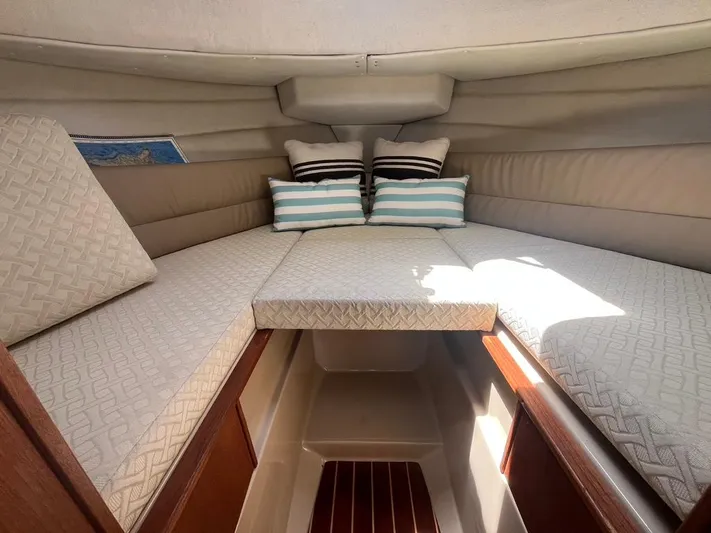 Ben Yacht Photos Pics 2011 Ranger Tugs R-27 cabin interior with cushioned seating and striped pillows.