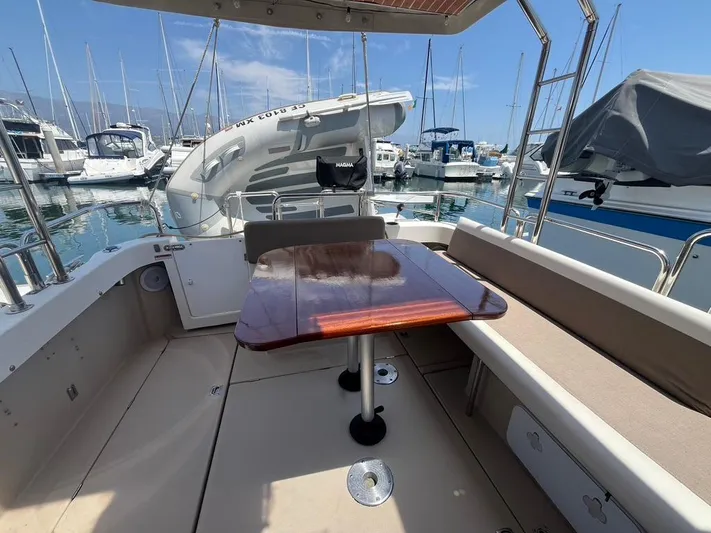 Ben Yacht Photos Pics 2011 Ranger Tugs R-27 boat interior with wooden table, docked at marina.