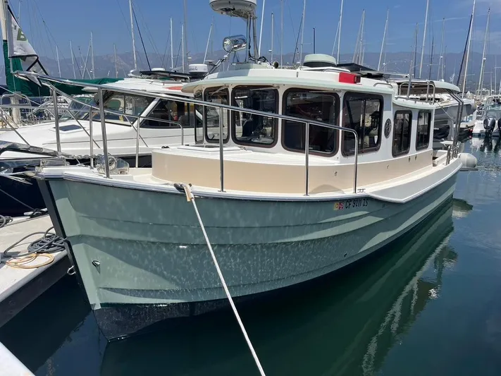 Ben Yacht Photos Pics 2011 Ranger Tugs R-27 boat docked in a marina, surrounded by other vessels.