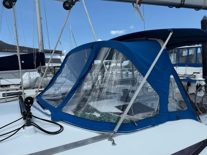 Corrine Yacht Photos Pics 2015 Jeanneau 409 sailboat with blue canopy and clear windows at marina.