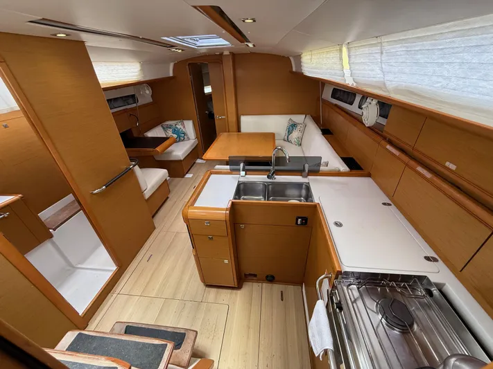Corrine Yacht Photos Pics Interior of 2015 Jeanneau 409 sailboat with modern kitchen and seating area.