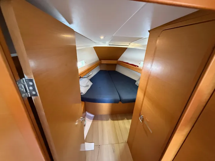 Corrine Yacht Photos Pics 2015 Jeanneau 409 cabin interior with wooden finish and blue bedding.