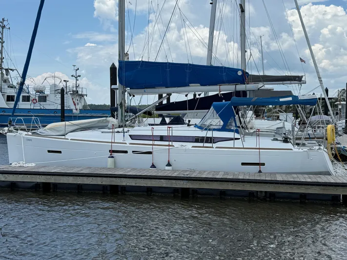 Corrine Yacht Photos Pics 2015 Jeanneau 409 sailboat docked at marina under cloudy sky.
