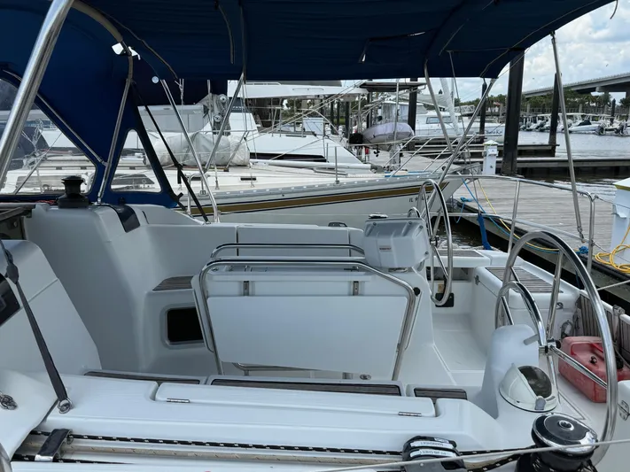 Corrine Yacht Photos Pics 2015 Jeanneau 409 sailboat cockpit with blue canopy, docked at marina.