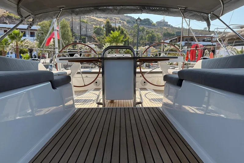 Bobbi Dazzler Yacht Photos Pics Cockpit view of 2013 Jeanneau 57 yacht with dual steering wheels and teak flooring.