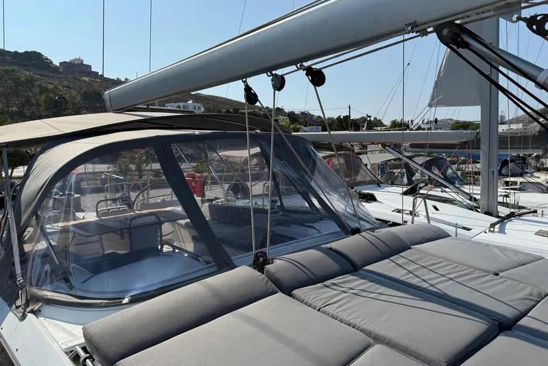 Bobbi Dazzler Yacht Photos Pics 2013 Jeanneau 57 yacht with sunbathing area and cockpit, docked in a marina.