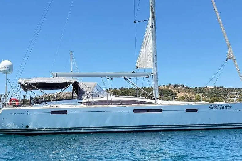 Bobbi Dazzler Yacht Photos Pics 2013 Jeanneau 57 sailboat on calm water under clear blue sky.