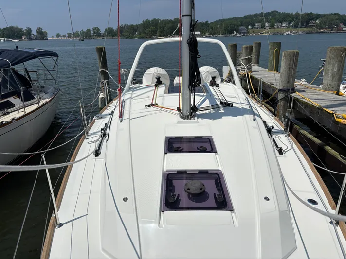 Aveyron Yacht Photos Pics 2021 Beneteau Oceanis 35.1 sailboat docked at a marina, showcasing its sleek deck design.