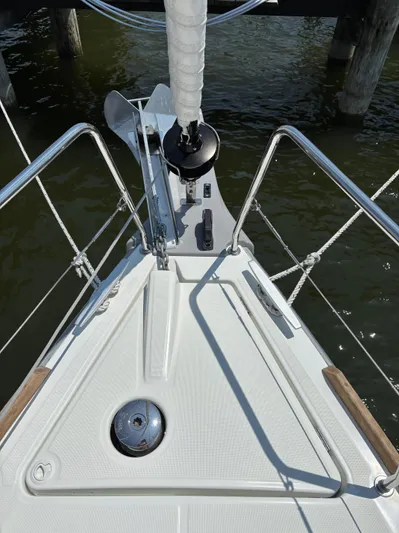 Aveyron Yacht Photos Pics Bow of 2021 Beneteau Oceanis 35.1 sailboat with anchor and railing, docked on water.