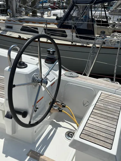 Aveyron Yacht Photos Pics Steering wheel of 2021 Beneteau Oceanis 35.1 sailboat in marina setting.