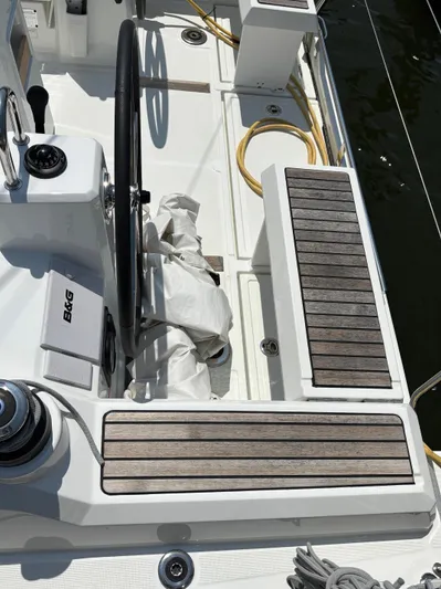 Aveyron Yacht Photos Pics Cockpit of 2021 Beneteau Oceanis 35.1 sailboat with steering wheel and wooden seating.