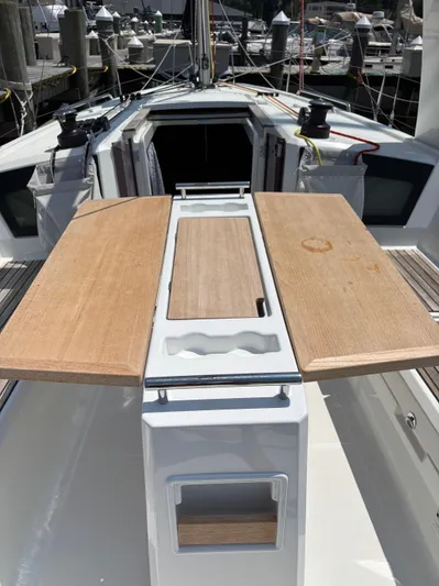 Aveyron Yacht Photos Pics Cockpit view of 2021 Beneteau Oceanis 35.1 sailboat with wooden table and winches.