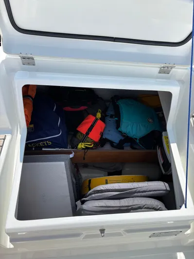 Aveyron Yacht Photos Pics Storage compartment of 2021 Beneteau Oceanis 35.1 sailboat with life jackets and gear.