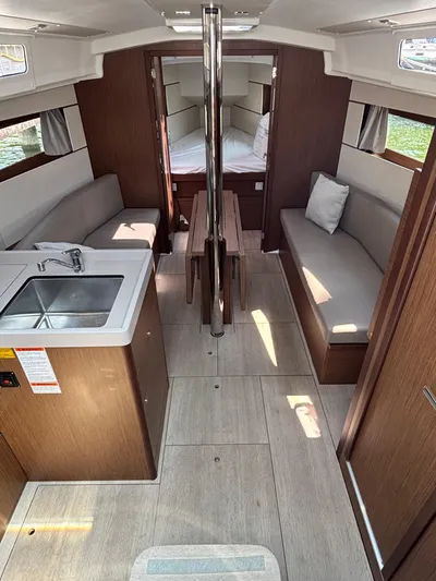 Aveyron Yacht Photos Pics Interior of 2021 Beneteau Oceanis 35.1 sailboat with modern wood finish and seating.
