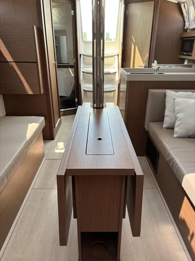 Aveyron Yacht Photos Pics Interior of 2021 Beneteau Oceanis 35.1 yacht, featuring modern wood finishes and seating.