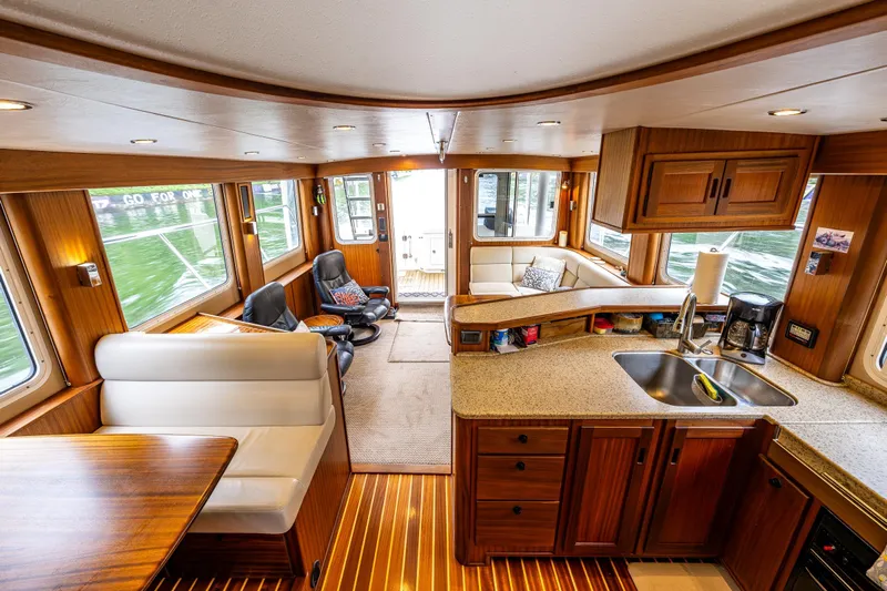 Pacific Rose Yacht Photos Pics Luxurious interior of 2009 American Tug 49 Limited with wood finishes and modern amenities.