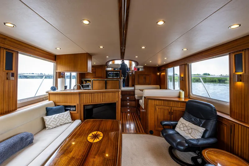 Pacific Rose Yacht Photos Pics Luxurious interior of 2009 American Tug 49 Limited yacht with wood finishes and comfortable seating.