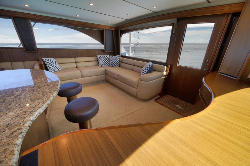 Even Flow Yacht Photos Pics Luxurious 2009 Viking Convertible yacht interior with plush seating and ocean view.