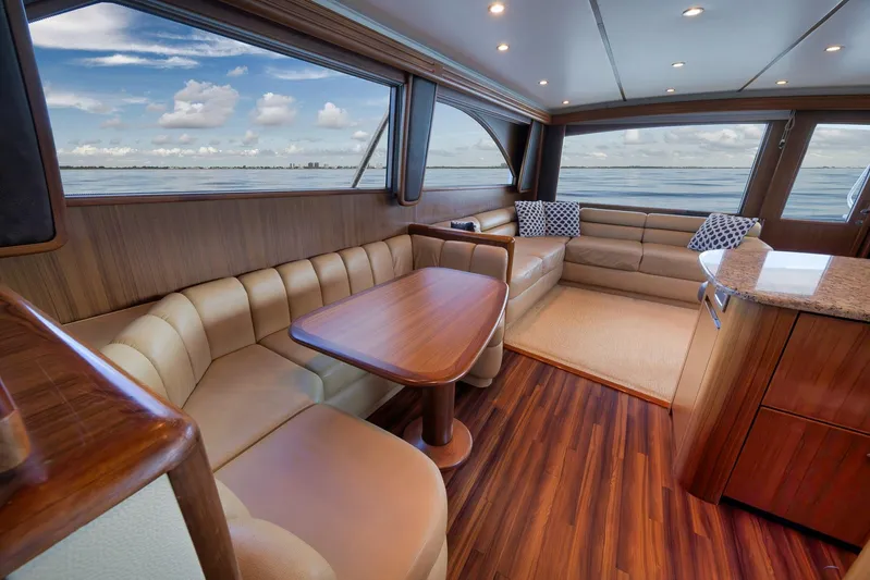 Even Flow Yacht Photos Pics Luxurious interior of a 2009 Viking Convertible yacht with elegant seating and ocean view.