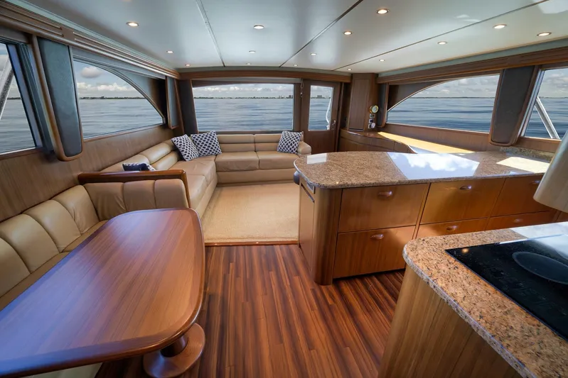 Even Flow Yacht Photos Pics Luxurious interior of a 2009 Viking Convertible yacht with elegant wood finishes and ocean views.