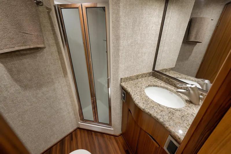 Even Flow Yacht Photos Pics Luxurious bathroom in 2009 Viking Convertible yacht with granite countertop and modern fixtures.