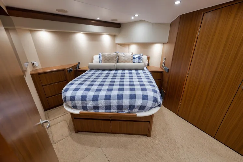 Even Flow Yacht Photos Pics Luxurious bedroom interior of 2009 Viking Convertible yacht with checkered bedding.