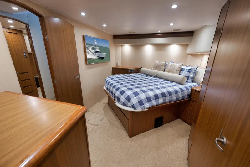 Even Flow Yacht Photos Pics Luxurious 2009 Viking Convertible yacht bedroom with wood accents and checkered bedding.