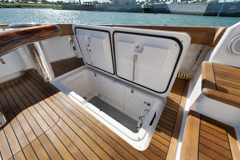 Even Flow Yacht Photos Pics 2009 Viking Convertible boat with open storage compartment on teak deck.