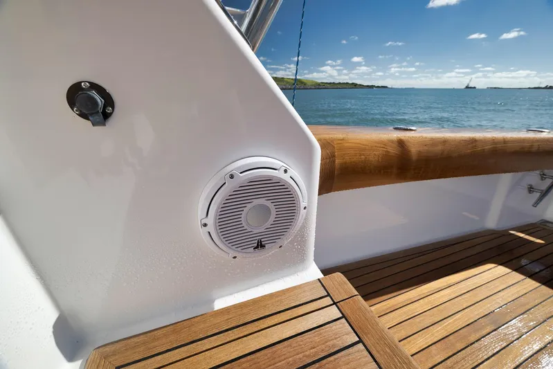 Even Flow Yacht Photos Pics 2009 Viking Convertible yacht deck with speaker, wooden railing, and ocean view.