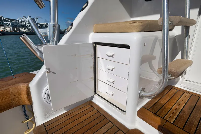 Even Flow Yacht Photos Pics 2009 Viking Convertible yacht interior with open storage cabinet and wooden flooring.