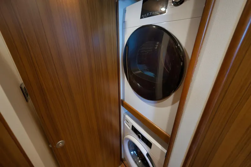 Even Flow Yacht Photos Pics Stacked washer and dryer in 2009 Viking Convertible yacht laundry area.