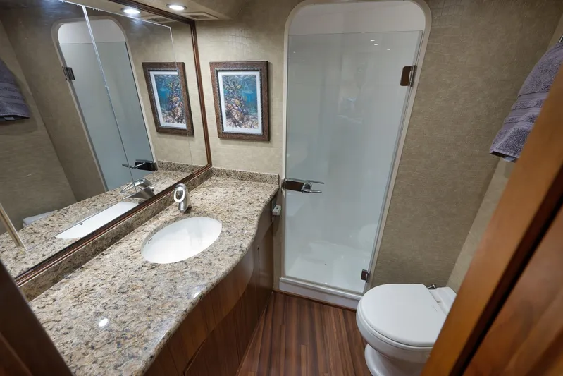 Even Flow Yacht Photos Pics Luxurious bathroom in 2009 Viking Convertible yacht with granite countertop and glass shower.