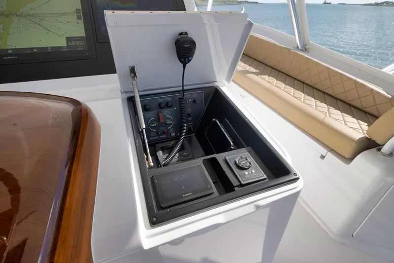 Even Flow Yacht Photos Pics Control panel of a 2009 Viking Convertible yacht with navigation equipment and seating.