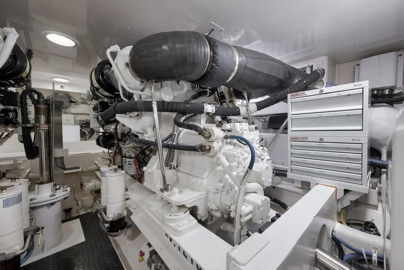 Even Flow Yacht Photos Pics Engine room of a 2009 Viking Convertible yacht, featuring complex machinery and tool storage.