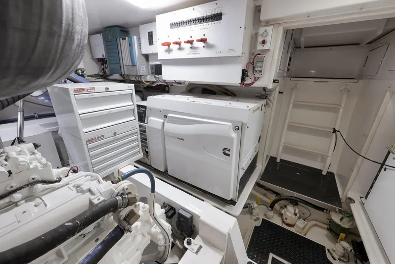 Even Flow Yacht Photos Pics Engine room of a 2009 Viking Convertible yacht with generator and control panels.