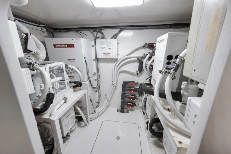 Even Flow Yacht Photos Pics Engine room of a 2009 Viking Convertible yacht with complex piping and equipment.