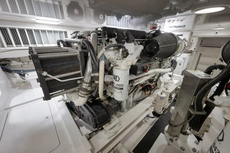 Even Flow Yacht Photos Pics Engine room of a 2009 Viking Convertible yacht, showcasing complex machinery and components.