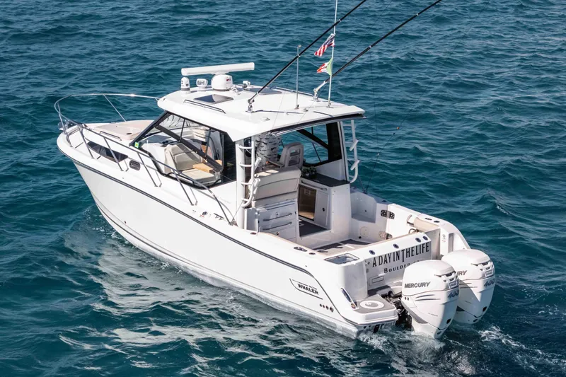 A Day In The Life Yacht Photos Pics 2021 Boston Whaler 325 Conquest boat cruising on open water.