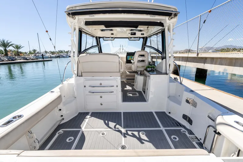 A Day In The Life Yacht Photos Pics 2021 Boston Whaler 325 Conquest boat interior, featuring spacious deck and modern amenities.