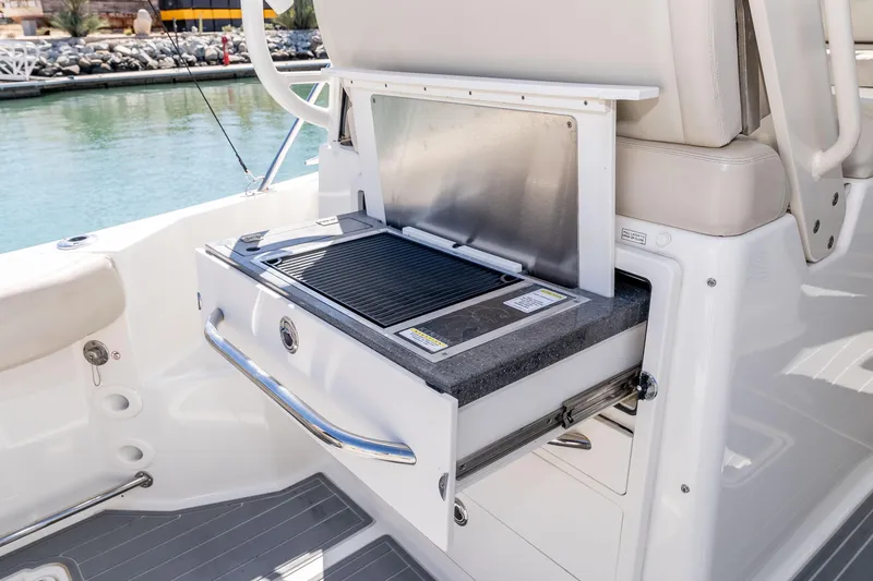 A Day In The Life Yacht Photos Pics 2021 Boston Whaler 325 Conquest boat with built-in grill on deck.