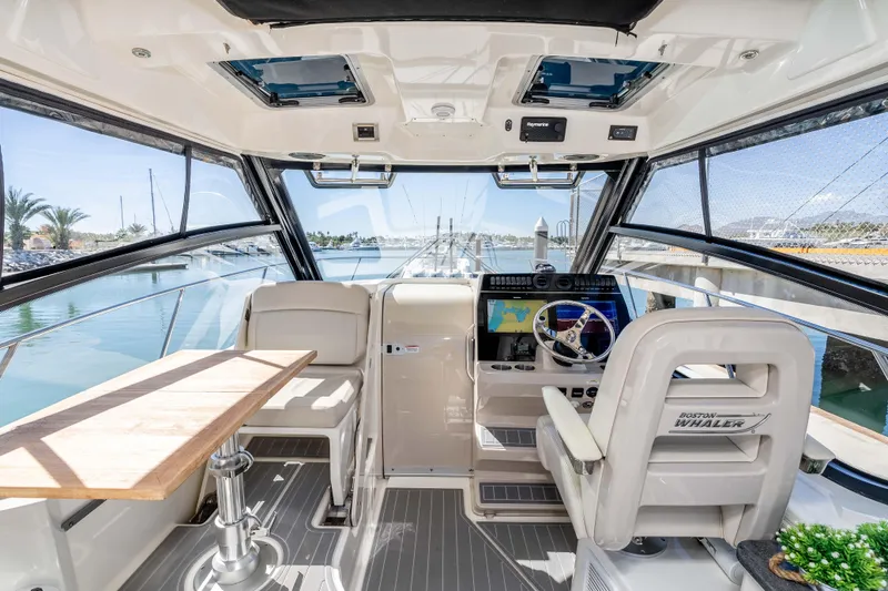 A Day In The Life Yacht Photos Pics Interior of 2021 Boston Whaler 325 Conquest boat with helm and seating area.